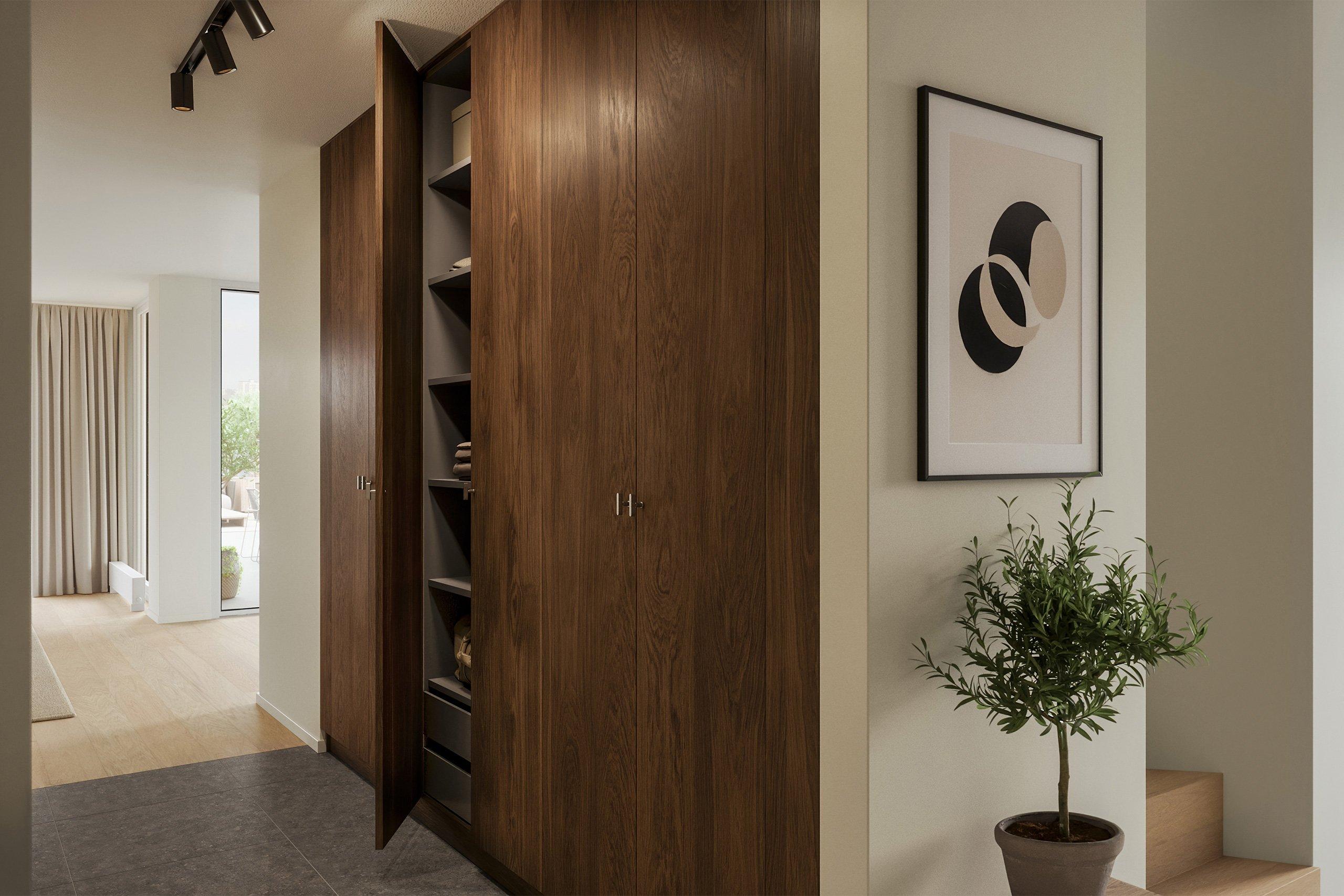 Entrén har en elegant och lite mörkare karaktär som kontrasterar fint mot bostadens i övrigt ljusa materialpalett (visionsbild)