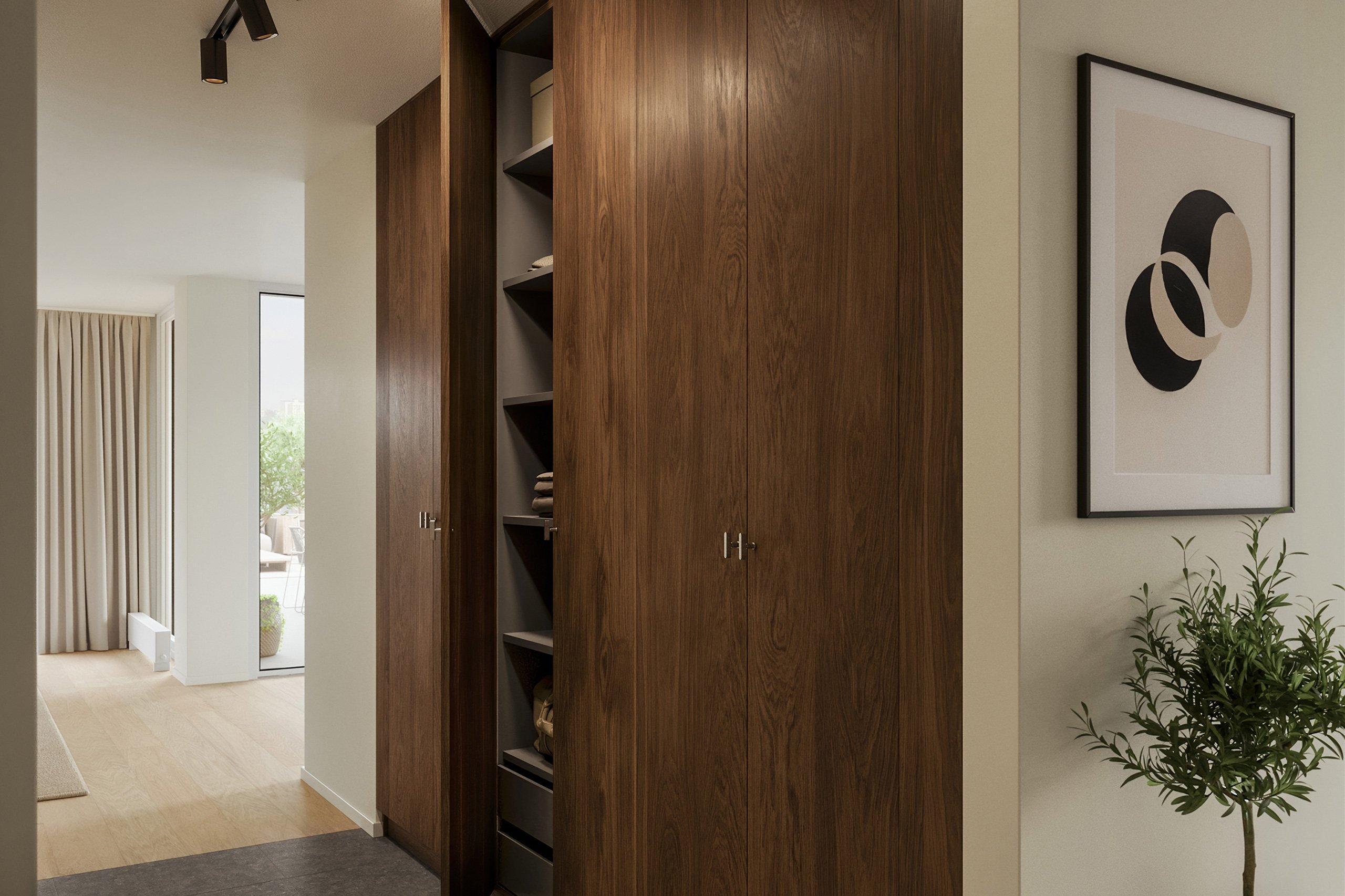 Entrén har en elegant och lite mörkare karaktär som kontrasterar fint mot bostadens i övrigt ljusa materialpalett (visionsbild)