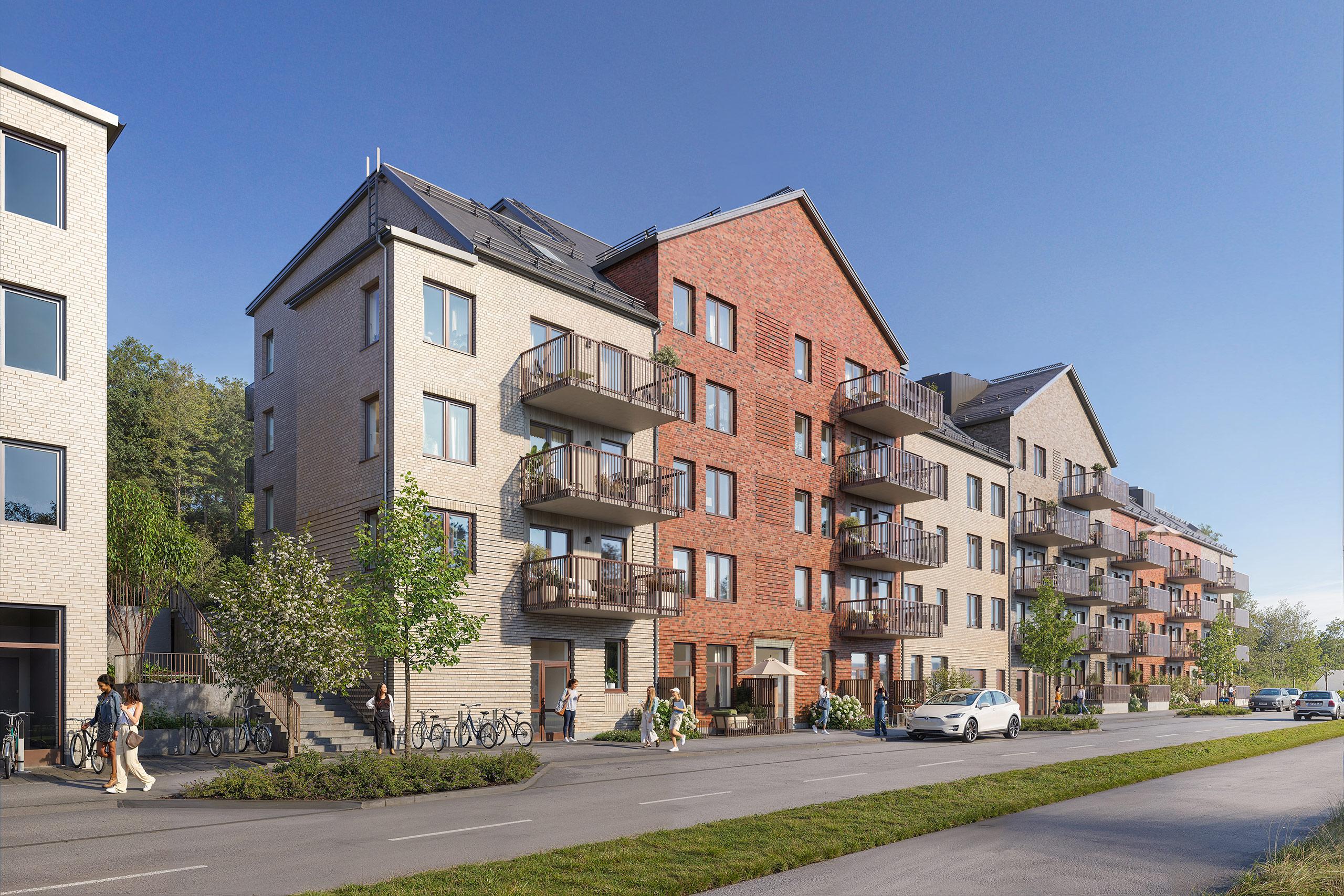 Modernt bostadshus med balkonger mot mindre gata.