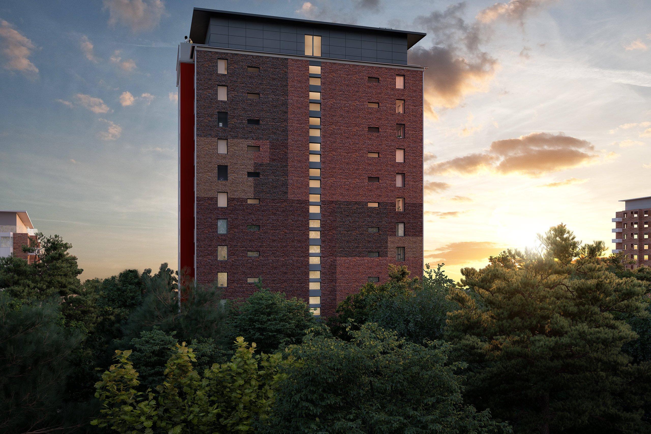 Högt bostadshus i tegel, skymningsljuset faller.