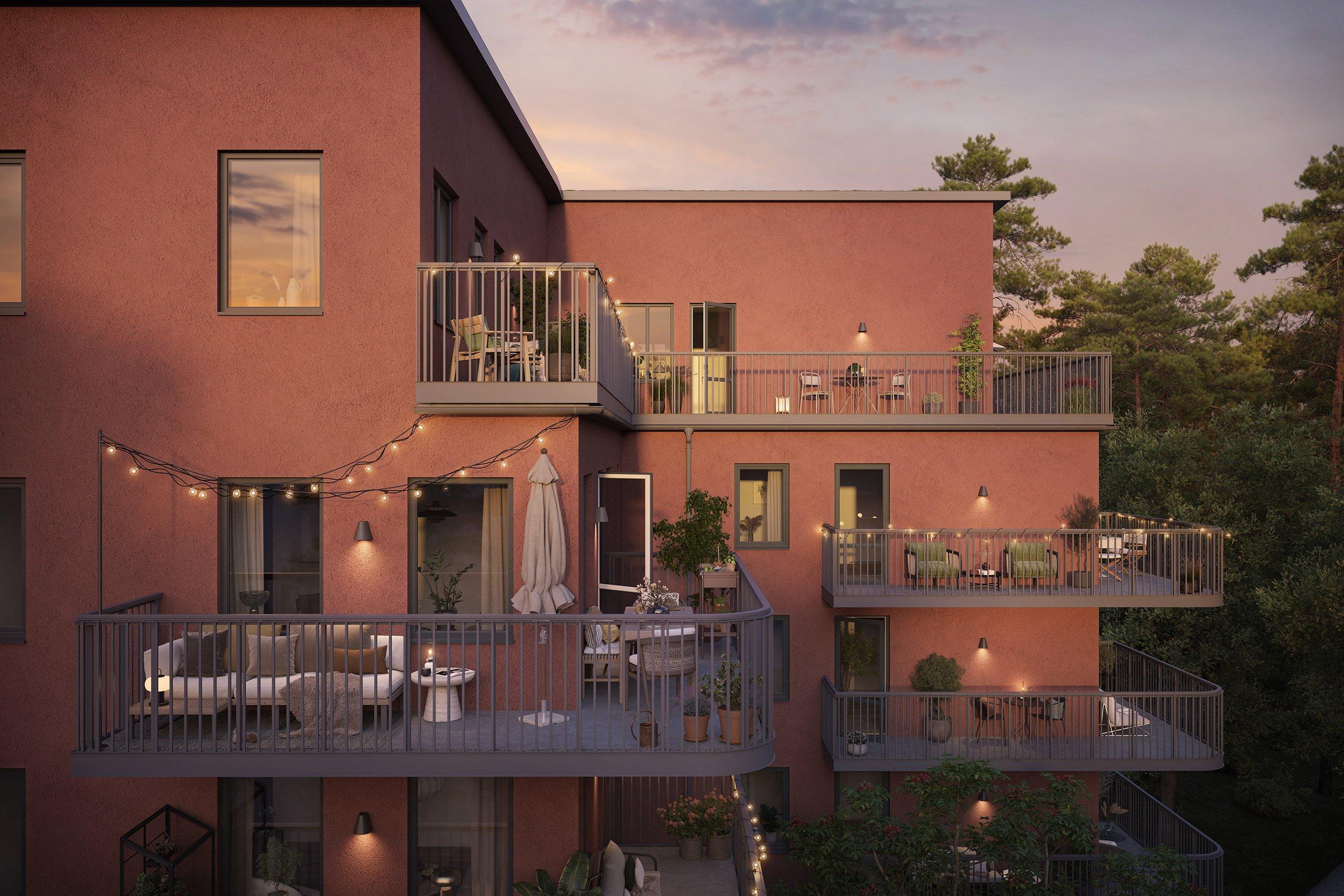 Roströd byggnad med luftiga balkonger.