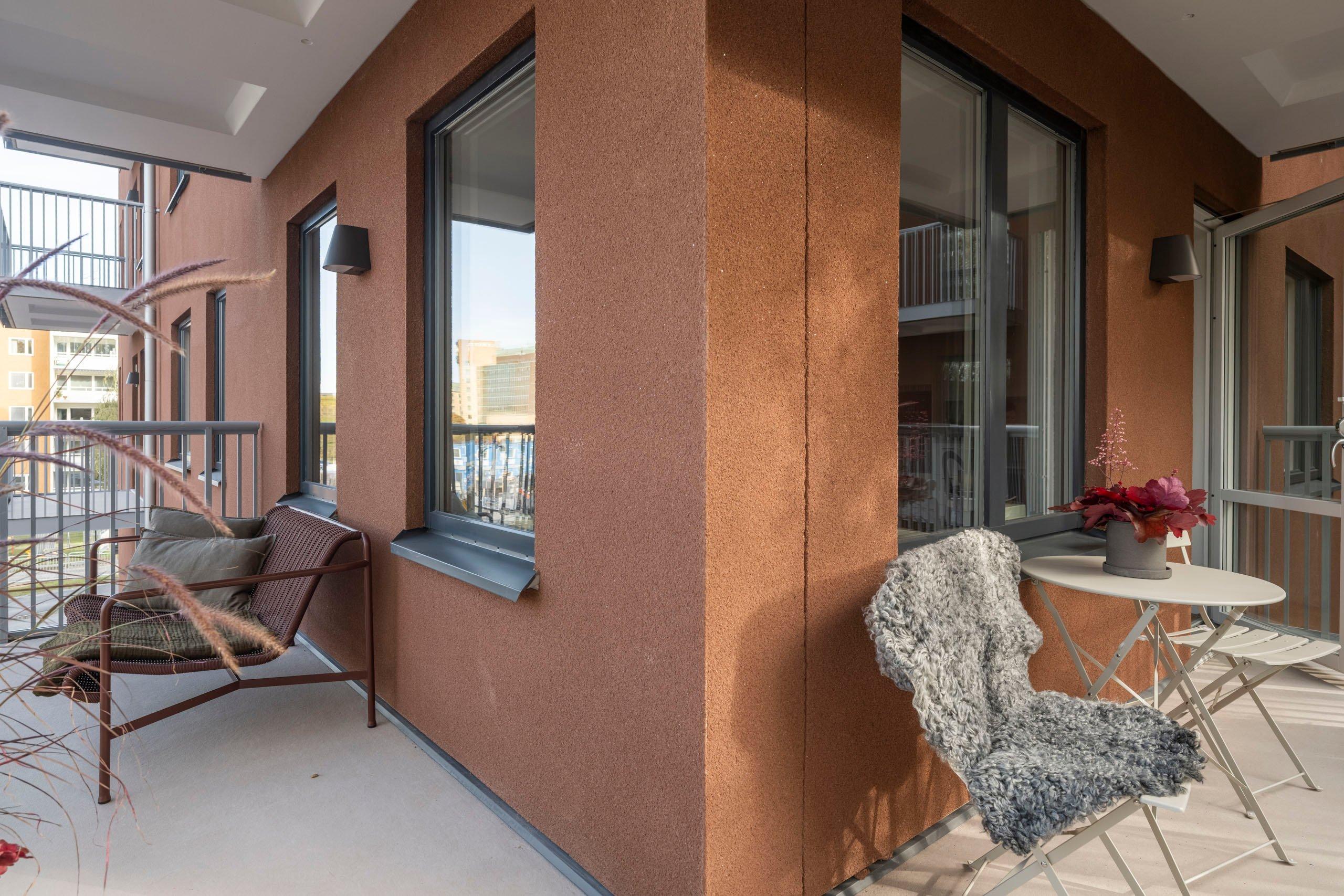 Hörnbalkong med sittmöbler.