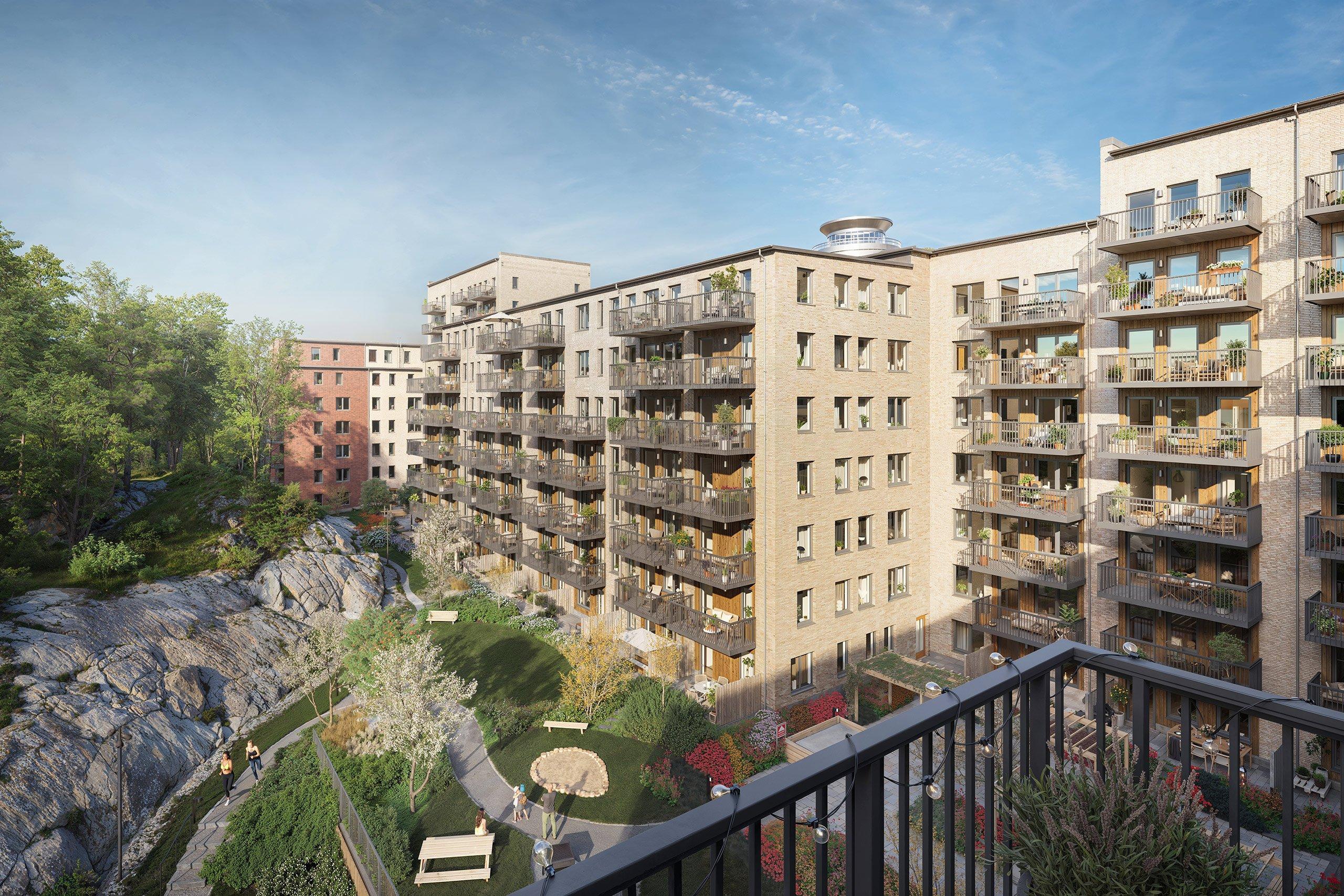 Balkong mot grön innergård och klippigt skogsparti.