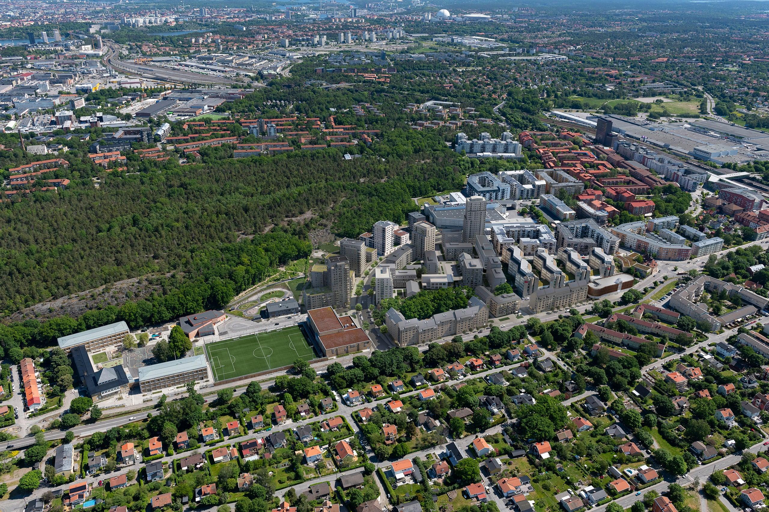 Bostadsområde vid fotbollsplan och stor skog.