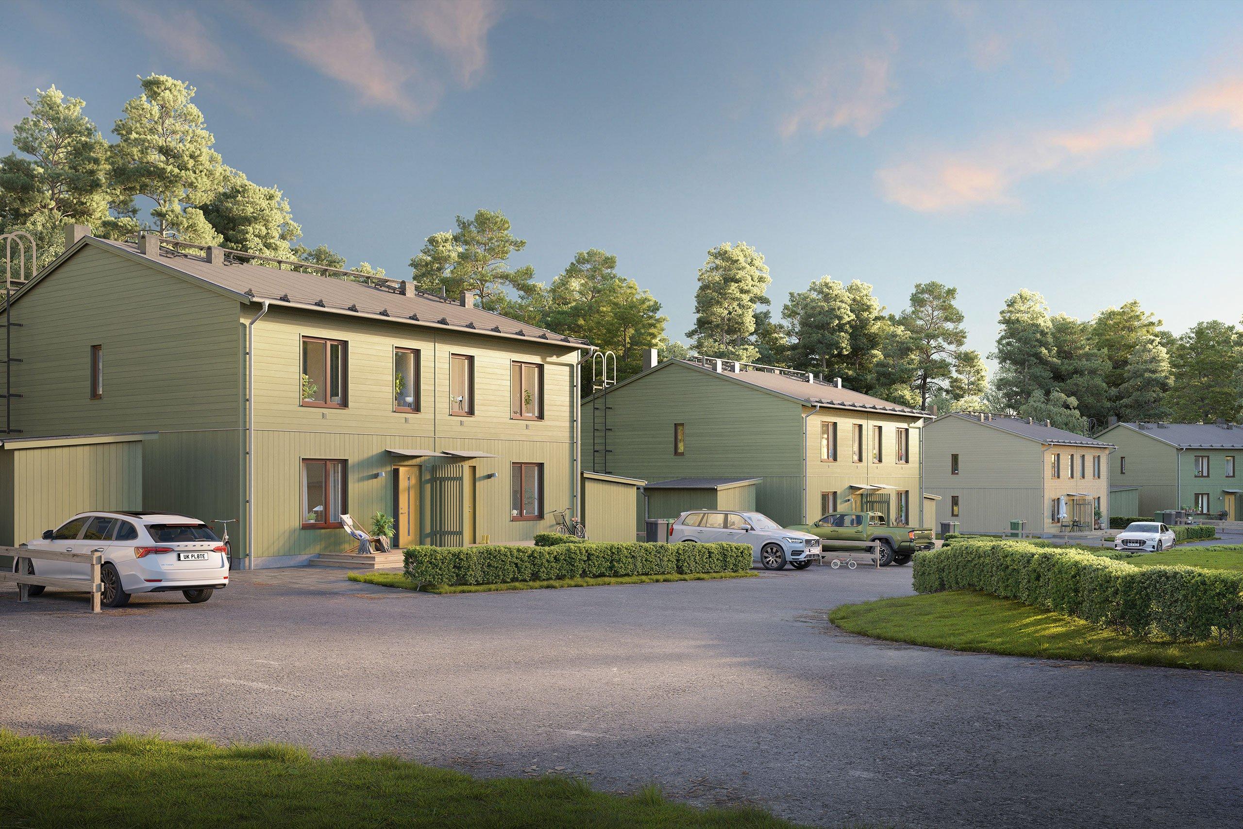 Parhus längs med gata med parkerade bilar framför tomten och träd i bakgrunden.