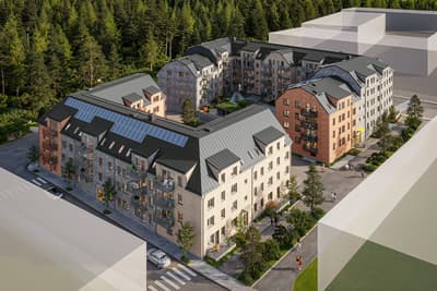 Modernt bostadskvarter vid lummig granskog.