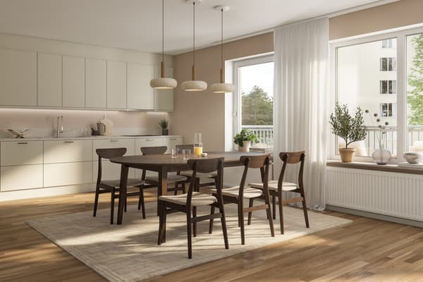 Köket är välplanerat med tidlösa materialval med bänkskiva i grå laminat som fortsätter upp på väggen i form av en bakkantslist och släta luckor. Vitvarorna är helintegrerade för ett stilrent uttryck (visionsbild).