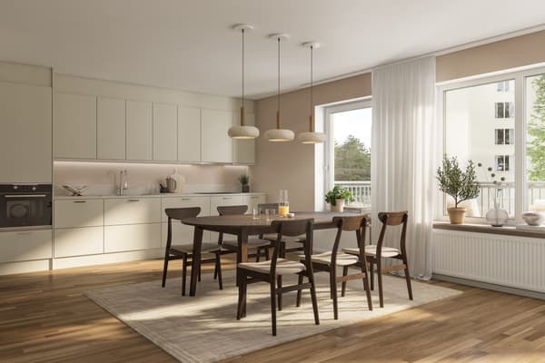 Köket är välplanerat med tidlösa materialval med bänkskiva i grå laminat som fortsätter upp på väggen i form av en bakkantslist och släta luckor. Vitvarorna är helintegrerade för ett stilrent uttryck (visionsbild).