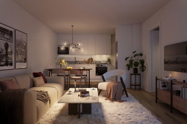 Köket är välplanerat med tidlösa materialval, bänkskiva i grå laminat som fortsätter upp på väggen i form av en bakkantslist och släta luckor. Vitvarorna är helintegrerade för ett stilrent uttryck (visionsbild).