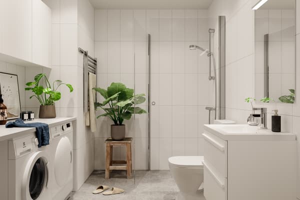 Badrummen får väggar i ett vitt stående kakel och ett ljust grått klinker på golven. De utrustas också med tvättmaskin och torktumlare (visionsbild).