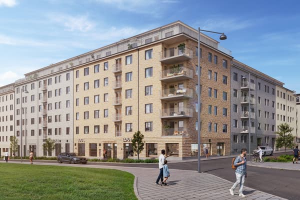 Husfasad i tegel framför stadsgata.