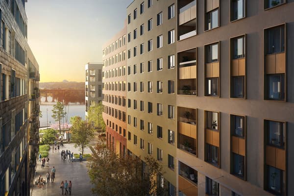 Lägenheter mot grön innergård med skymt av Årstaviken.