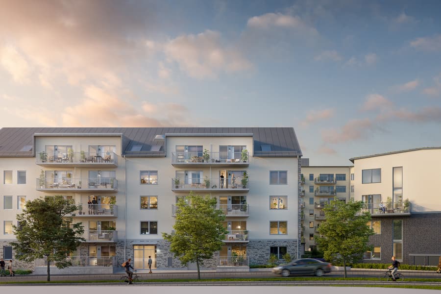 Ljust bostadskvarter mot trädkantad stadsgata.