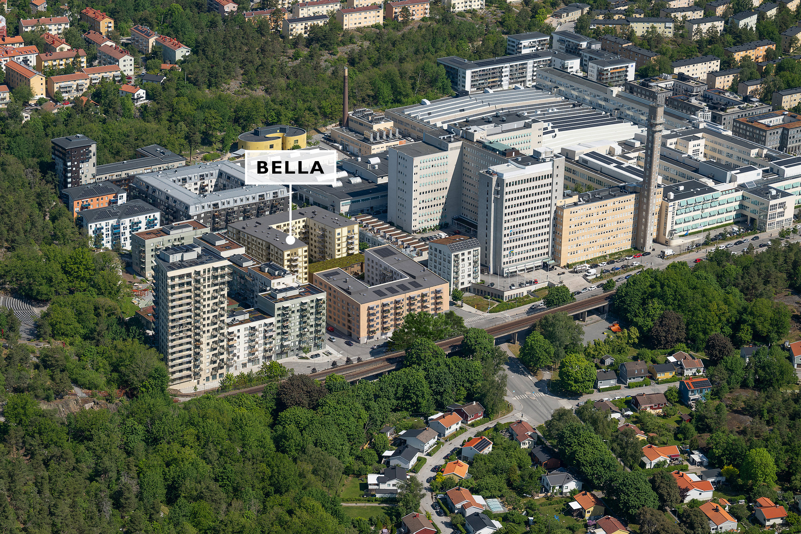 Flera bostadskvarter omgivna av lummigt skogsparti.